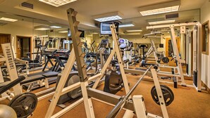 A gym with various exercise machines, mirrors, and a television. - 4 Mi to Breckenridge Resort: Condo w/ Sauna Access (Breckenridge)