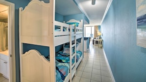 A bunk bed room with a bathroom and a desk. - Spectacular Oceanfront Emerald Beach Resort Condo (Panama City Beach)