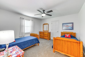 A bedroom with two single beds, a dresser, a mirror, a ceiling fan, and a framed picture on the wall. - Watts Bar Lake Escape: Private Boat Dock + Ramp! (Spring City)