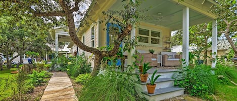 A covered porch with a wooden walkway leading to a house.
