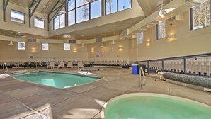 An indoor swimming pool with clear views through large windows, a sunlit ceiling, and a tiled floor. - Silverthorne Condo W/pool Access - Shuttle to Town (Silverthorne)