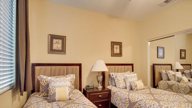 A hotel room with two beds, a nightstand with a lamp, and framed pictures on the wall. - Indio Home W/private Pool & Putting Green By Golf (Indio)