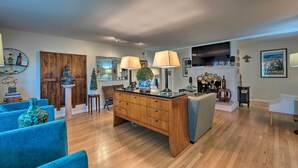 A spacious living room with a wooden coffee table, blue armchairs, and a fireplace. - Spacious Wine Country Home: 1 Mi to Downtown Lodi! (Lodi)