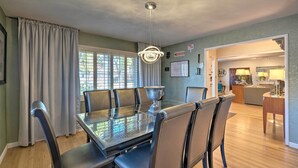 A dining area with a glass table, chairs, and a chandelier. - Spacious Wine Country Home: 1 Mi to Downtown Lodi! (Lodi)