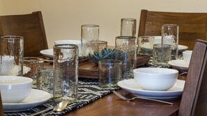 A dining table set with white plates, bowls, and clear glassware. - Cottonwoods 419 (Moab)