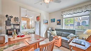 A cozy living room with a sofa, a dining table with chairs, a ceiling fan, and artwork on the walls. - Chula Vista Studio w/ Hot Tub ~ 9 Mi to Downtown (Chula Vista)