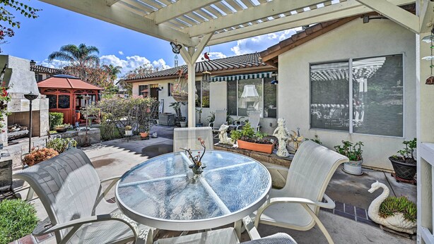 A covered patio with a round table and chairs, surrounded by potted plants and outdoor furniture. - Chula Vista Studio w/ Hot Tub ~ 9 Mi to Downtown (Chula Vista)