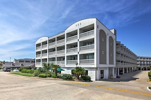 Hotel de vários andares com design arquitetônico moderno, com varandas e área de estacionamento.