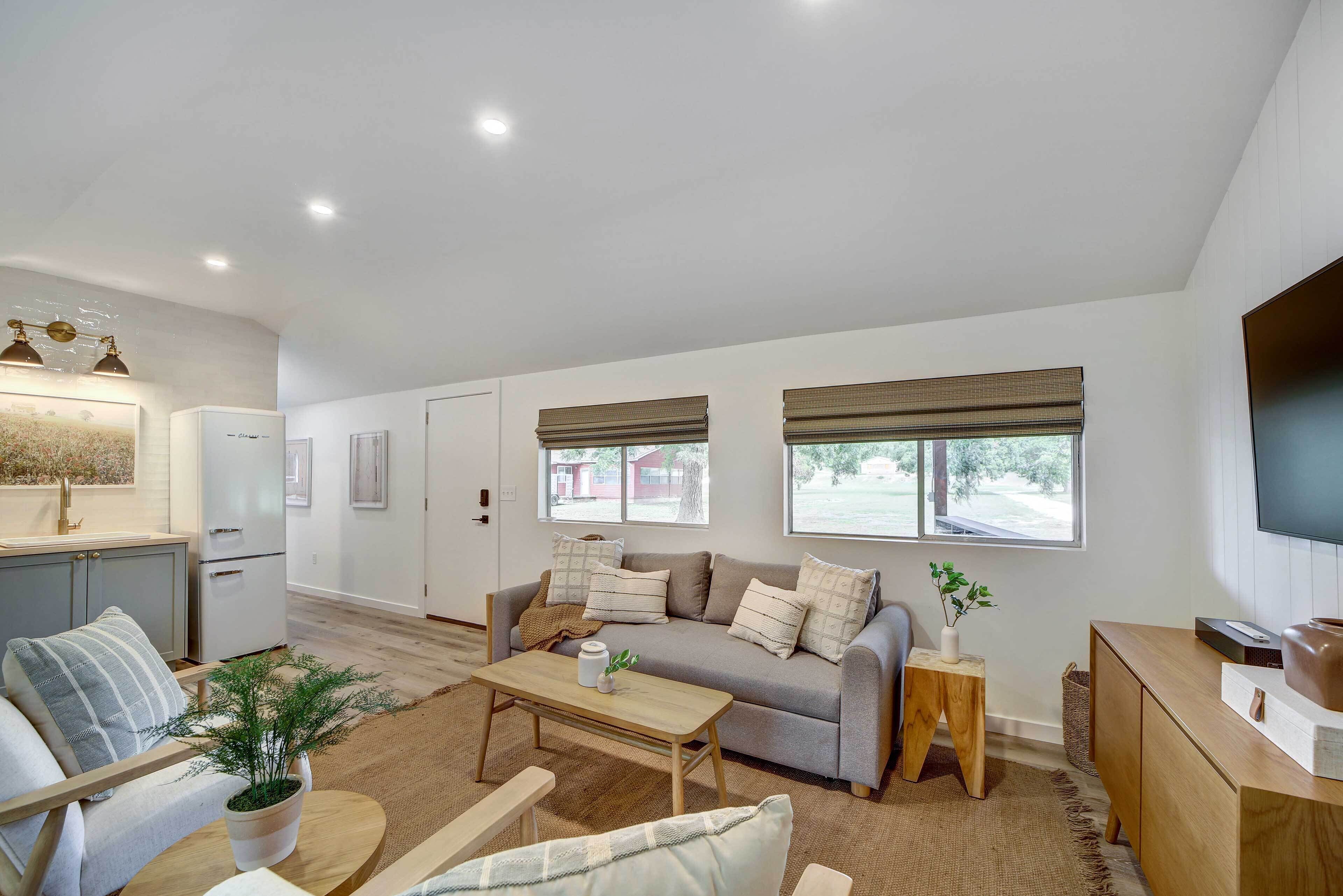 A modern living room with a sofa, coffee table, and a TV.