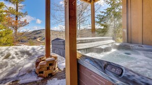 A hot tub with a control panel, surrounded by wooden beams and a snowy landscape with trees and mountains in the background. - Private Hot Tub: Scenic Granby Vacation Rental! (Granby)