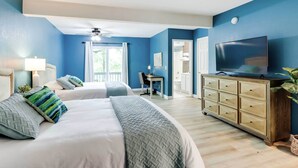 A bedroom with two beds, a TV, a desk, and a dresser. - Families w/ Pets! Lake-view Osage Beach Home (Osage Beach)