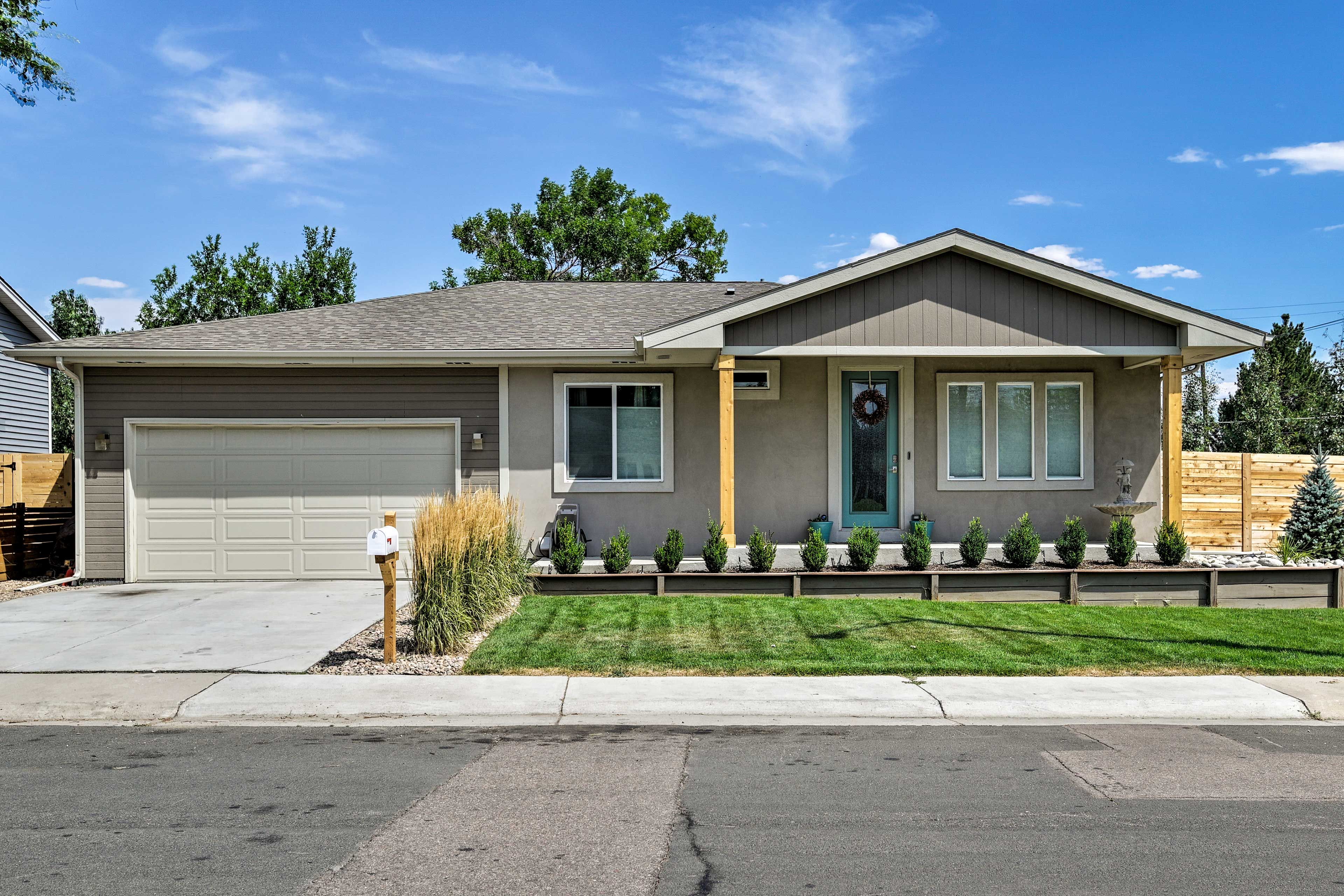 A single-story house with a garage, a front porch with a small fountain, and a well-maintained lawn.