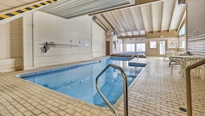 An indoor swimming pool with a tiled floor, a metal pool ladder, and a ceiling with wooden beams. - All-season Resort Condo: 5 Mi to Dillon Reservoir (Silverthorne)