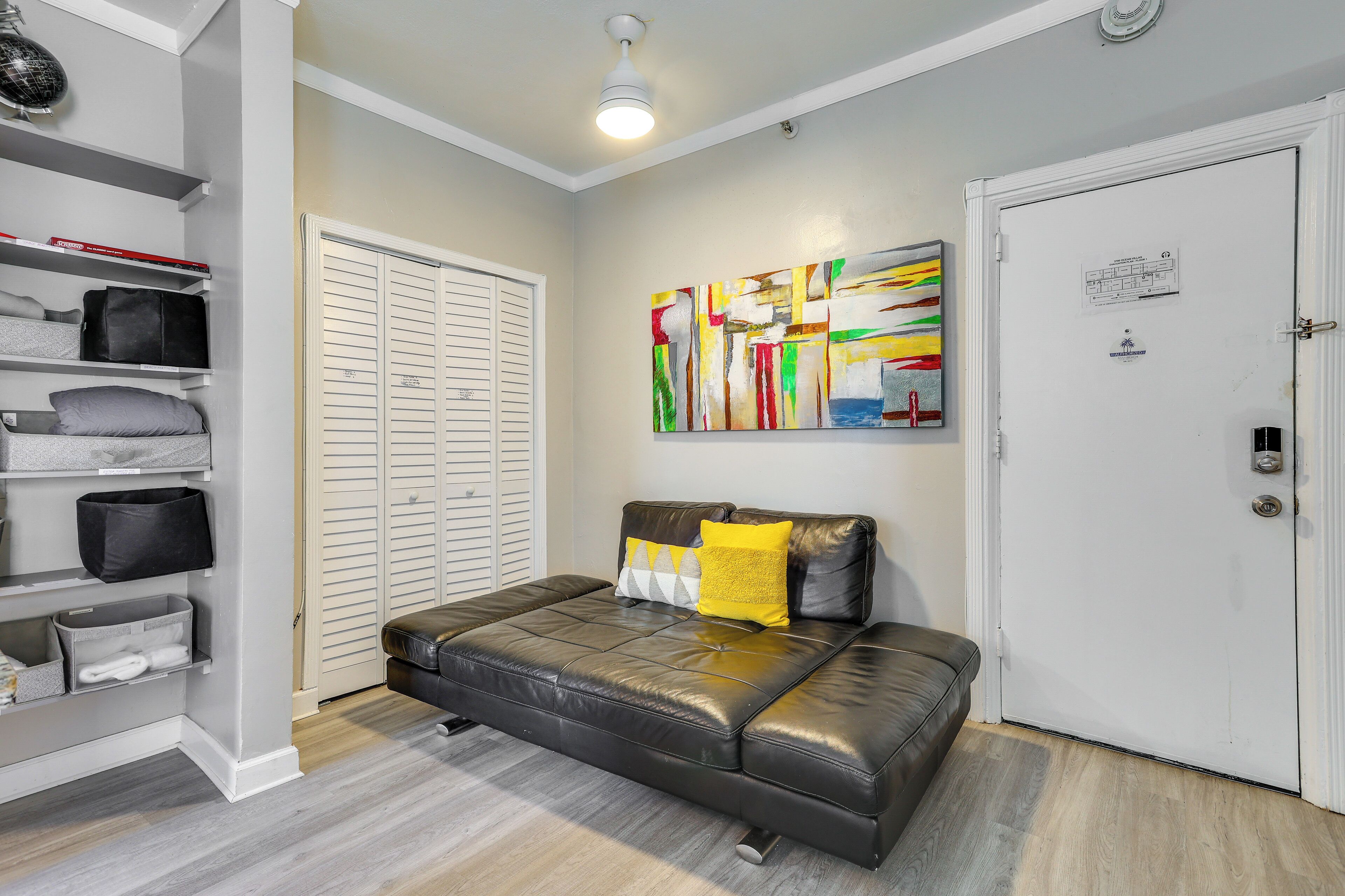 A bedroom with a bed, a closet, and a door.