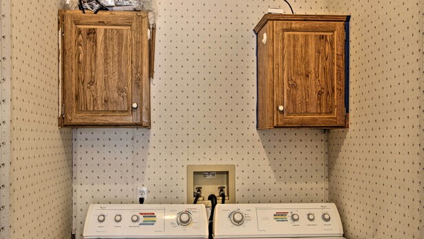 A laundry area with two wooden cabinets and a double electric washer and dryer. - Packwood Cabin <20 Mi to Mt Rainier Adventure (Packwood)