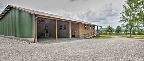 A building with a green exterior and a covered porch area.