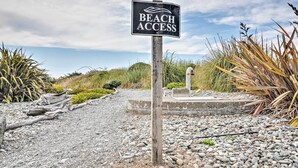 A beach access sign with a pathway leading to the beach. - Quiet Waterfront Escape w/ Hot Tub & Beach Access! (Gold Beach)