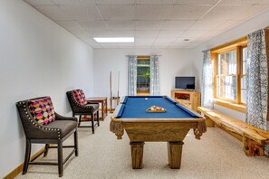 A room with a pool table, two chairs, a television, and a window with patterned curtains. - 'A Bit of Heaven' Cabin < 13 Miles From Boone! (Fleetwood)