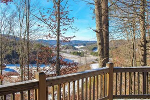 A wooden deck overlooking a valley with trees and a distant view of mountains. - 'A Bit of Heaven' Cabin < 13 Miles From Boone! (Fleetwood)