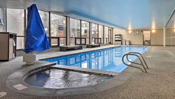 An indoor swimming pool with a hot tub, seating area, and a covered bench. - Spacious Vail Condo: Steps From Eagle Bahn Gondola (Vail)