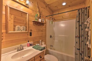 A wooden cabin bathroom with a sink, toilet, and bathtub. - Lake Lure Log Cabin w/ Grill, Near Hiking! (Lake Lure)