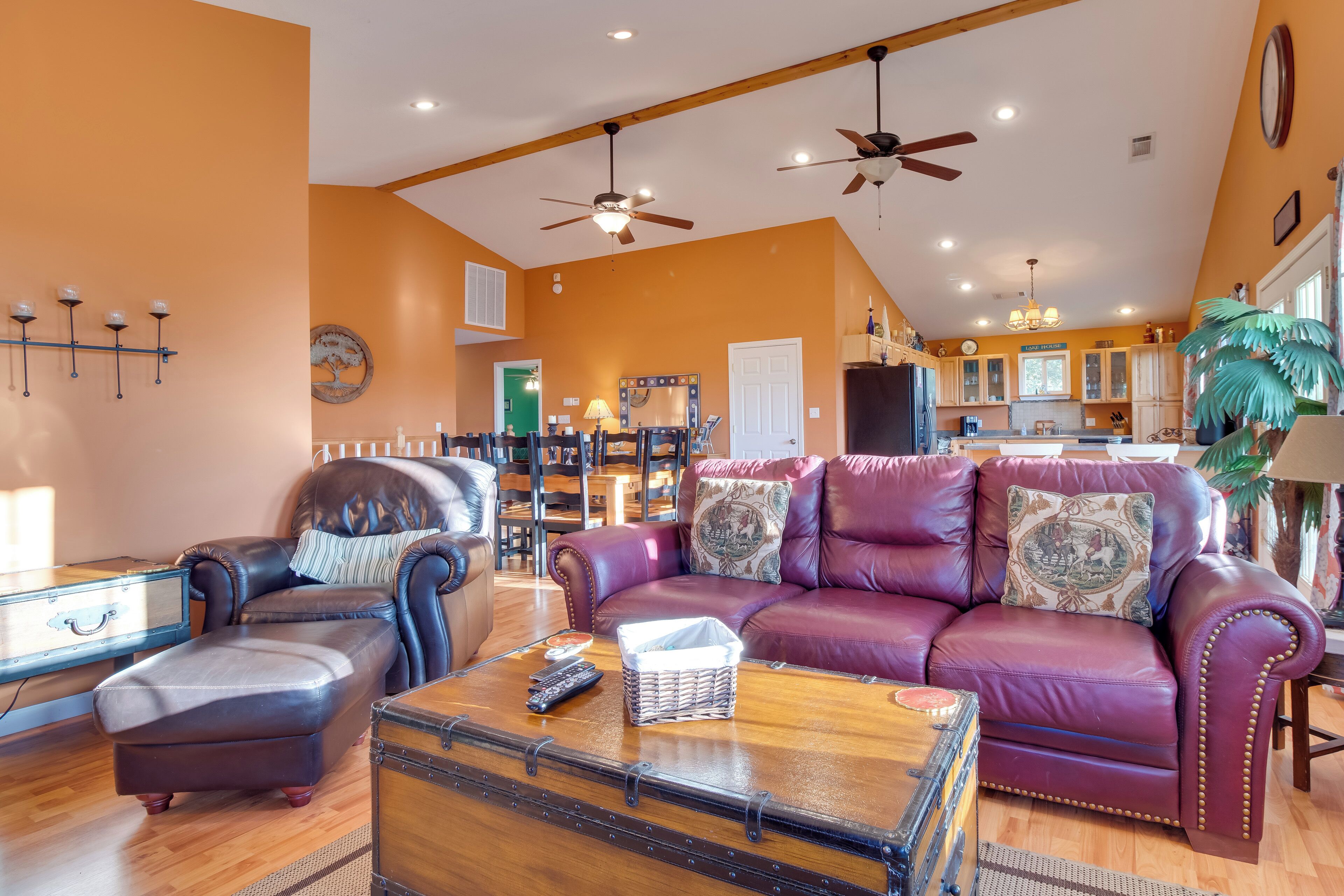 A spacious living room with leather sofas, a wooden coffee table, and a vintage trunk.