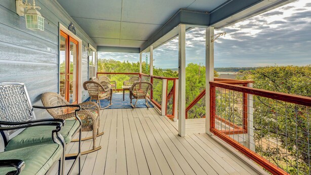 A covered porch with wicker chairs and a table, overlooking a scenic landscape. - Canyon Lake Getaway w/ Fire Pit, Boat Ramp Nearby! (Canyon Lake)