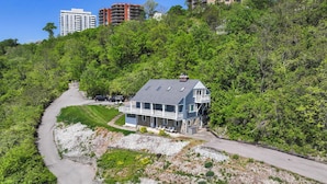 A two-story house with a balcony, surrounded by lush greenery and a winding driveway. - Riverview Hideaway, 3 Mi to Dtwn Cincinnati (Cincinnati)
