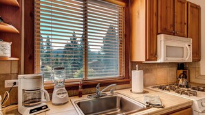 A kitchen with wooden cabinets, a stainless steel sink, a coffee maker, a blender, and a microwave. - Inviting Ski Getaway < 1 Mile to Northstar Resort! (Truckee)