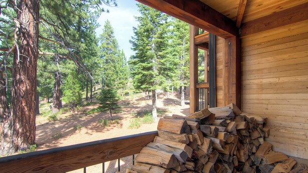A wooden cabin with a deck overlooking a forest. - Inviting Ski Getaway < 1 Mile to Northstar Resort! (Truckee)