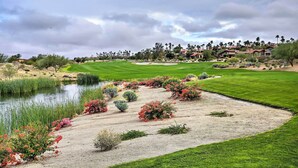 A golf course with a pond, landscaped areas, and a residential area in the background. - 'roadrunner Roost' at Rams Hill Golf Resort! (Borrego Springs)