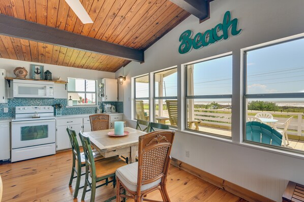 Enjoy a meal with a view of the beach from this kitchen's large windows.