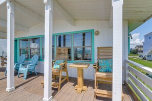 Relax in a serene outdoor space with Adirondack chairs and a small table.