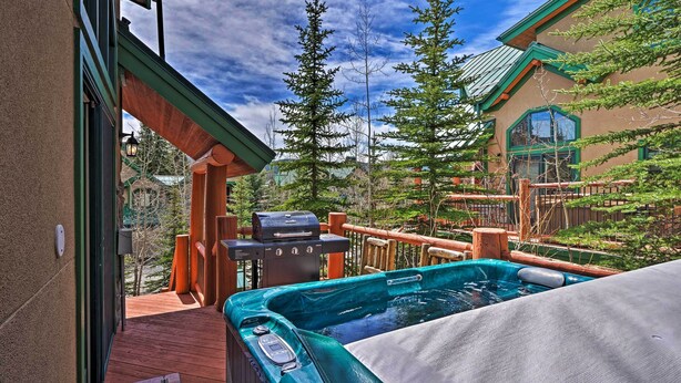A hot tub on a wooden deck with a view of a mountain and trees. - Beautiful Breck Retreat: Walk to Gondola & Main St (Breckenridge)