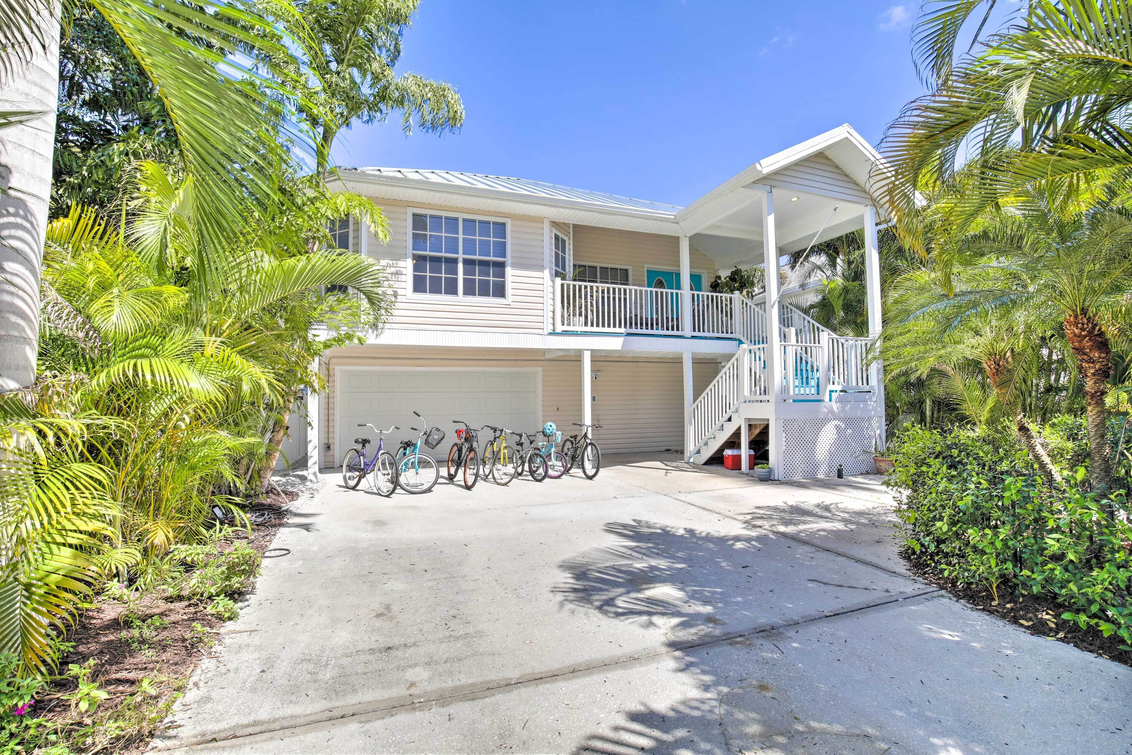 A two-story house with a covered porch, a staircase, and a pool.
