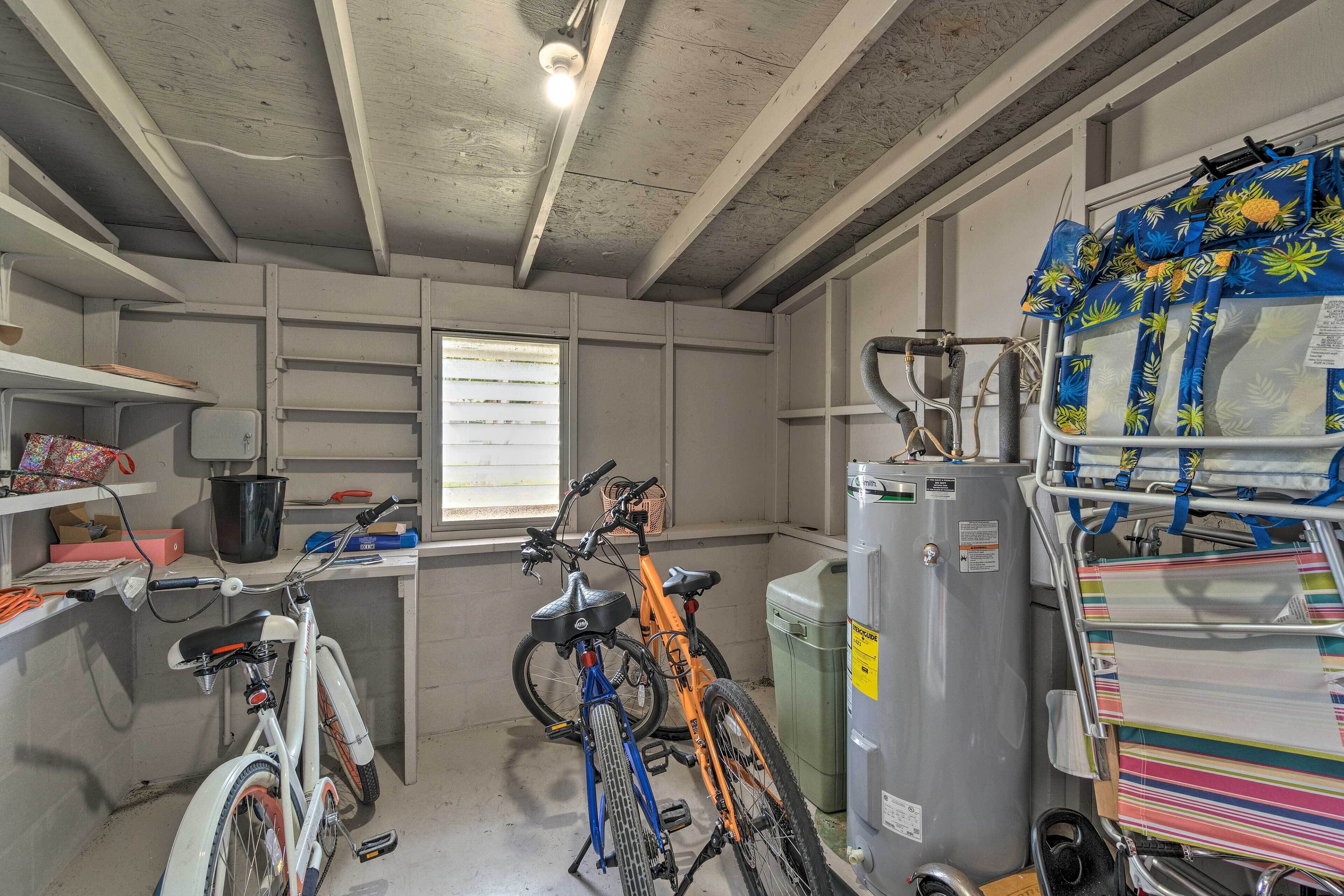A utility room with bicycles, a water heater, and storage shelves.