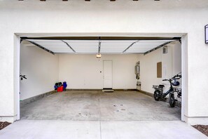 A garage with a white door, a bicycle, and a red toolbox. - 4 Mi to Beach! San Juan Capistrano Home w/ Patio (San Juan Capistrano)