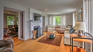 A spacious living room with a fireplace, comfortable seating, and a view of the outdoors. - Queen City Home w/ Ohio River View - 3 Mi to Dtwn! (Cincinnati)