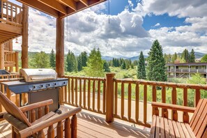 A wooden deck with a grill and seating area overlooking a forested landscape. - Cozy Condo w/ Views, 3 Mi to Winter Park Resort! (Winter Park)