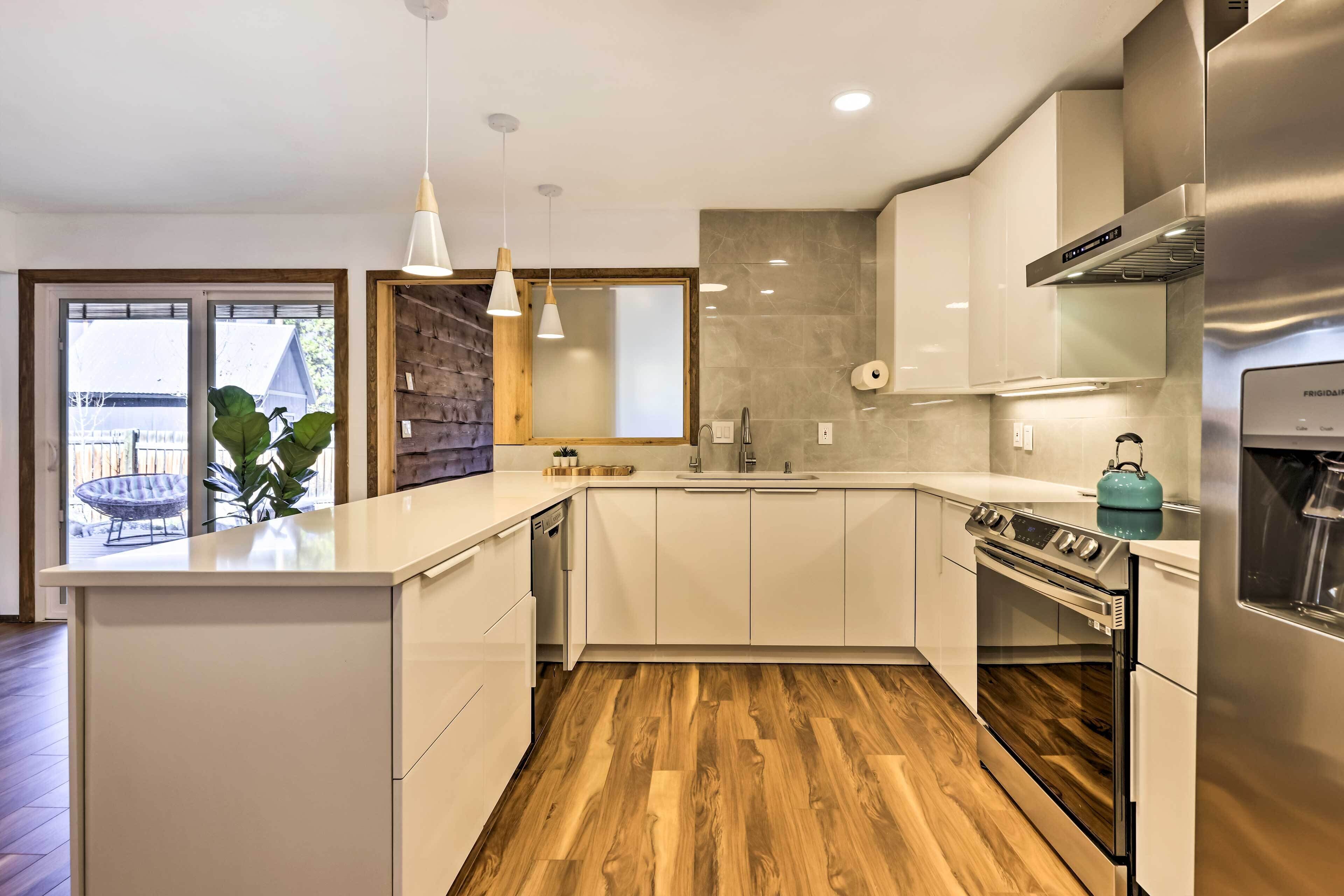 A modern kitchen with white cabinetry, a wooden floor, and a built-in oven.