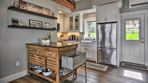A kitchen with wooden cabinetry, a stainless steel refrigerator, and a wooden island with drawers and a sink. - 'traveler's Retreat' Studio w/ Patio & Yard! (Tualatin)