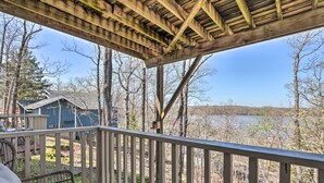 A wooden deck with a railing overlooking a lake, surrounded by trees. - Lake View! Family Resort Retreat in Osage Beach (Osage Beach)