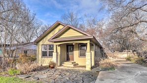A single-story house with a stone-paved front yard and a small porch. - Pet-friendly Austin Home w/ Private Yard + Deck! (Austin)