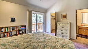 A bedroom with a bed, a bookshelf, a dresser, and a door leading to a balcony. - 4 Mi to Heavenly: Home w/ Deck in South Lake Tahoe (South Lake Tahoe)