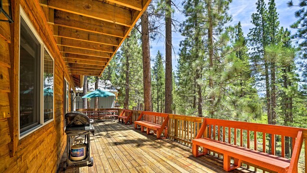 A wooden deck with benches and a grill, surrounded by tall pine trees. - 4 Mi to Heavenly: Home w/ Deck in South Lake Tahoe (South Lake Tahoe)