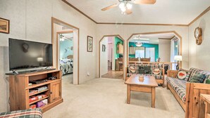 A living room with a television, wooden entertainment center, and a sofa. - Franklin Home w/ Deck, & Fire Pit: 8 Mi to Dtwn! (Franklin)
