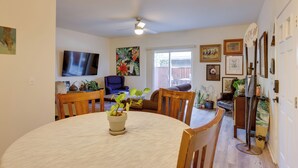 A dining area with a round table, chairs, and a ceiling fan. There are potted plants on the table and chairs. - Bright Bend Home w/ Patio < 3 Mi to Downtown! (Bend)