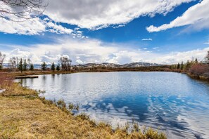 A serene lake surrounded by trees and mountains. - Riverfront Cabin, 4 Mi to Granby Ranch (Granby)