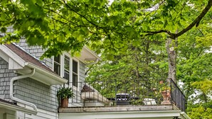 A white house with a balcony, a chimney, and a tree in the background. - Door County Retreat ~ 3 Mi to Sister Bay Beach (Sister Bay)