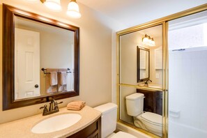 A bathroom with a large mirror, a sink, a toilet, and a shower. - Chic & Cozy Breck Condo: Ski-in/ski-out at Peak 8! (Breckenridge)